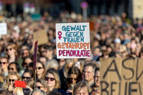Berlin, Germany - 22.3.2026: Demonstrators, including one holding up a poster with the inscription: