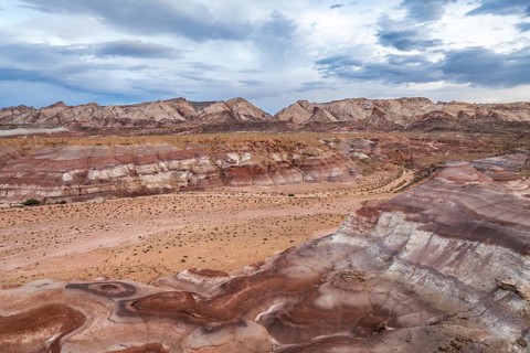 A striking aerial drone shot captures the diverse, rugged terrain of Hanksville, Utah, showcasing