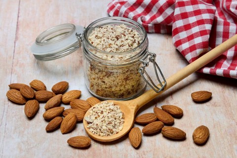 Almonds and ground almonds in glass, Prunus amygdalus