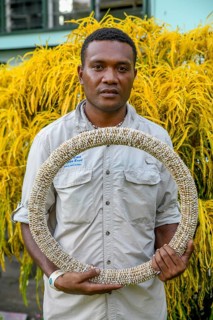 Native of the Tolai tribe with a hoop Shell money made from the shells of the Nassa snail