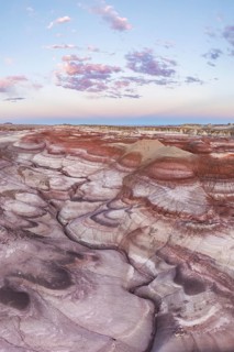 Captivating aerial image of the twisted and colorful bentonite hills in Utah, USA, under a sky