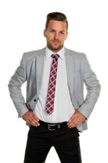 A man (manager or entrepreneur) stands in front of a white background, studio shot