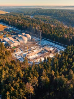 Bird's eye view of industrial building and construction site in the snowy forest, new fire station,