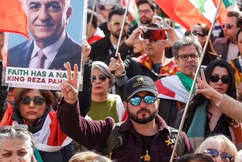 An Iranian wears a baseball cap with the inscription Make Iran Great Again during an Iran demo for