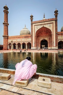 DELHI, INDIA, JUNE 24, 2012: Woman in Jama Masjid, the largest mosque in India. Delhi, India