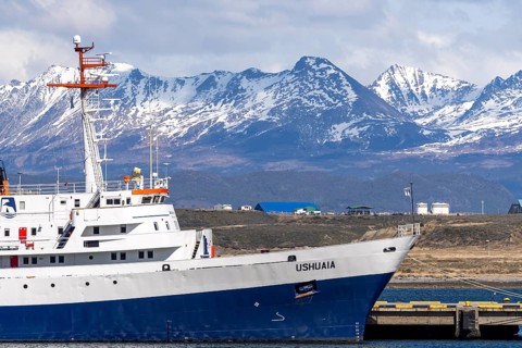 Expedition ship Ushuaia at the pier, snow-capped Andean mountains in the background, Ushuaia