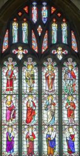 Stained glass east window inside Church of All Saints, Castle Cary, Somerset, England, UK by