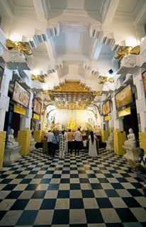 Sri Lankan pilgrims at the golden Buddha in the Buddhist Temple of the Tooth or Sri Dalada