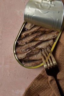 Sprats in oil, canned smoked fish, open, close-up, top view, no people