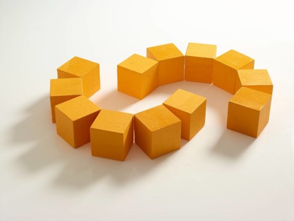 12 yellow wooden cubes against a white background