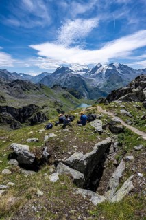 Mountaineers resting in a mountain landscape, descent at Col du Louvie, view of the summit of the