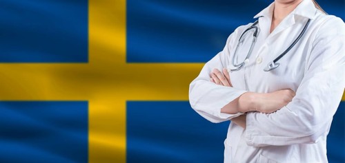 Doctor with crossed arms on Swedish flag. Sweden health and care concept. Female doctor on Swedish