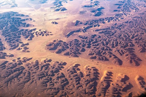 Aerial view of extensive sand dunes and geomorphological forms in a desert environment, The dunes