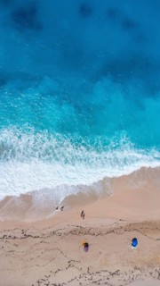 Aerial drone aerial shot in summer on paradise sandy beach Megali Petra in Lefkada. Beautiful