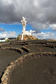 Stone walls in semicircles, viticulture in volcanic ash, Monumento al Campesino, monument to