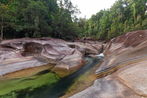 Turquoise blue water between rocks in the tropical rainforest of Babinda Boulders Queensland