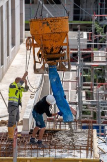 Construction site, concreting, concreting the balcony of a building, the concrete is pumped onto