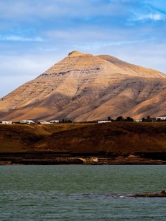 Majestic volcanic peak in Timanfaya National Park, Lanzarote, set against a vibrant blue sky with a
