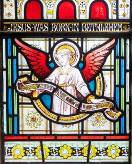 Details of stained glass window of an angel by Clayton and Bell, church of Saint James, Avebury,