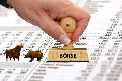 Bull and bear on a list with shares, stamp, stock exchange