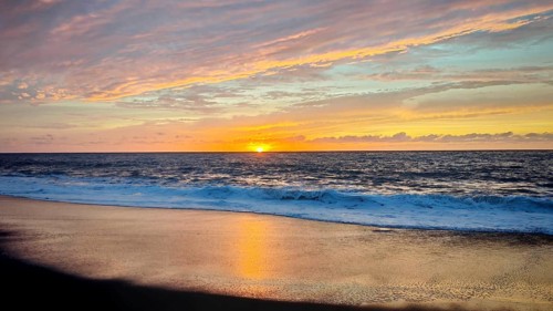 Sunset at sea shows a colorful spectacle in the sky and reflects on the water, hiking, Tarrafal de
