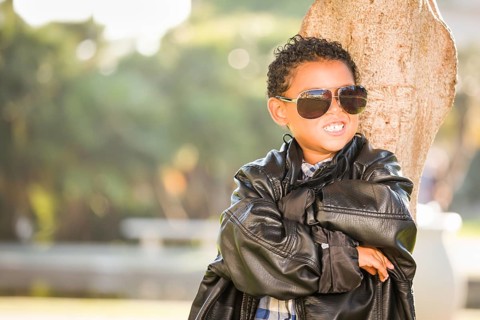 African American and Mexican Boy Dressed Up with Sunglasses and Leather Jacket