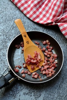 Fried bacon cubes in pan, bacon