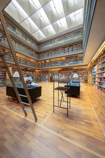 Modern library with high bookshelves, reading area and large windows, Weimar, Germany
