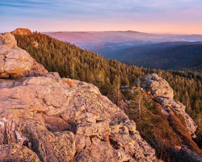 Sunset on the summit of the Großer Arber, view over rocks and endless forests, Bavarian Forest,