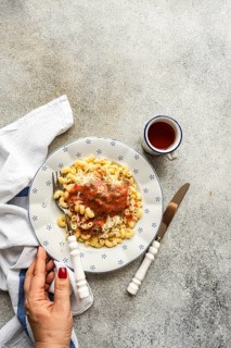 A delicious plate of chifferi rigati pasta topped with a flavorful tomato sauce, garnished with