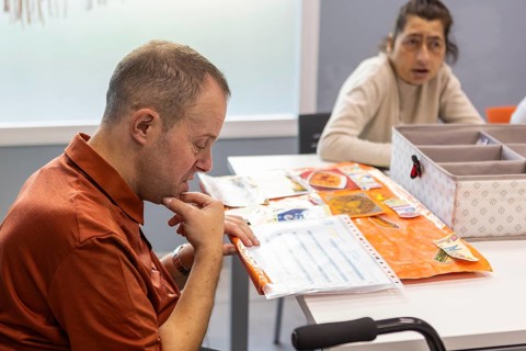 Individuals engage in meaningful activities at a day center for intellectual disabilities. The