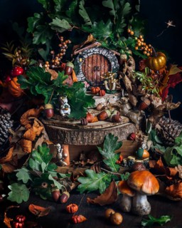 A whimsical miniature forest scene captures the essence of autumn with vibrant leaves, mushrooms,
