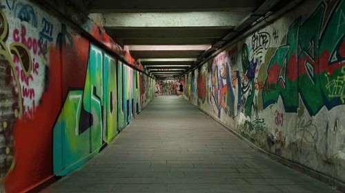 Long tunnel full of colorful graffiti leading into the distance, Georgia