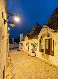 Street with Trulli houses by night, Rione Monti, Alberobello, Apulia - Puglia, Italy