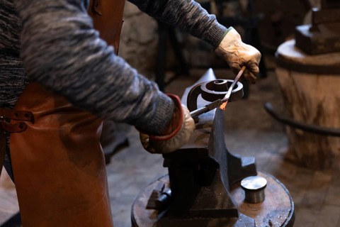 An elderly blacksmith in Salzburg preserves centuries-old blacksmithing traditions. His skilled