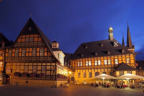 Market square with gothic town hall and street shop, lighting, blue hour, twilight, night view,