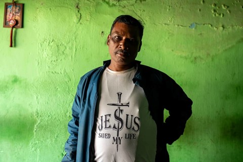 Portrait of a man follower of the christian faith in tribal Odisha, India. Photographed in a