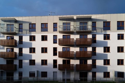 Facade of an apartment block with balconies in the afternoon sun