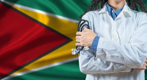 Healthcare professional with Guyana flag background. Professional doctor holding stethoscope on