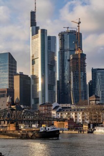 Skyline of the city centre of Frankfurt am Main, river Main, Eiserner Steg bridge, freighter, dusk,