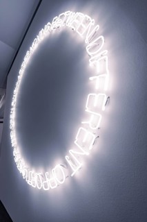 A circle of glowing neon letters on the wall creates a modern work of art, Schauwerk Sindelfingen,