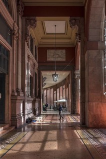 Arcaded walkway with mosaic floor from Palazzo della Borsa, built between 1907 and 1912, in Piazza