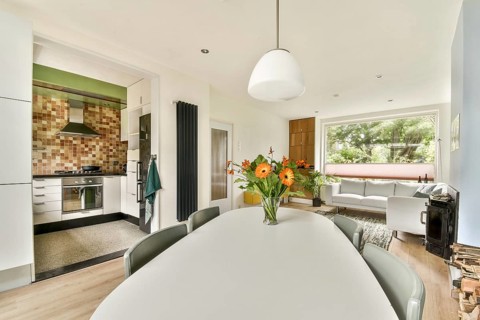 Bright open concept kitchen and living area featuring a modern design. A cozy living room with a