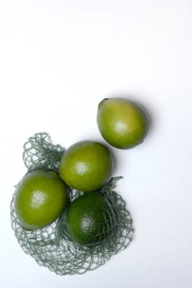 Limes with packing net, citrus fruits