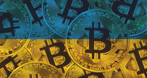 Golden bitcoin on Ukraine flag background. Bitcoin coins on Ukraine flag background