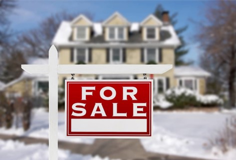 Home For Sale Real Estate Sign in Front of New Snow Covered House