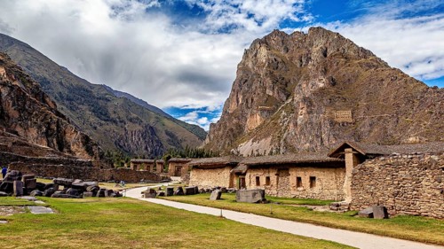 Mountain landscape with ancient ruins and blue sky, dramatic clouds, The Inca ruins of