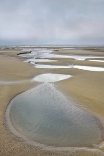 Tide pools on sand beach at low tide at Cap Blanc Nez, Pas-de-Calais, France