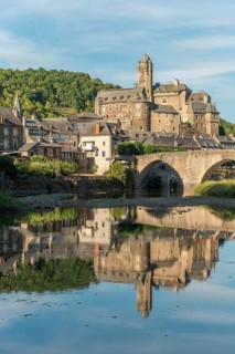 Medieval bridge over Lot with castle in village of Estaing. Aveyron, France