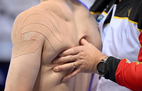 Massage Physio, back of Scarlet badis Sissakis GER Gymnastics, EnBW DTB-Pokal, Porsche-Arena,